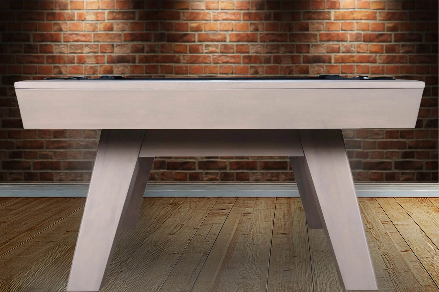 White pool table against a brick wall