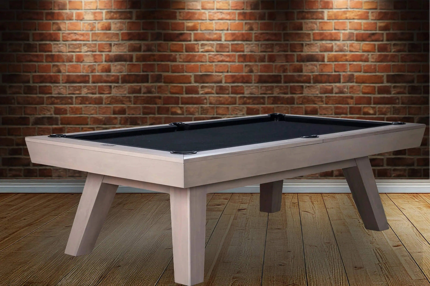 Modern pool table against a brick wall