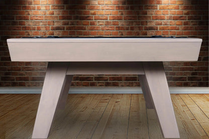 White pool table against a brick wall